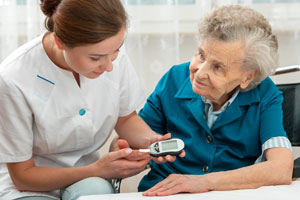 nurse providing care to senior woman