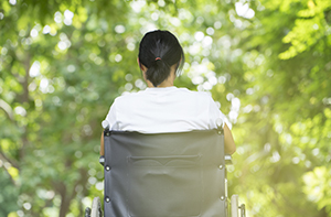 woman in wheelchair staring at nature