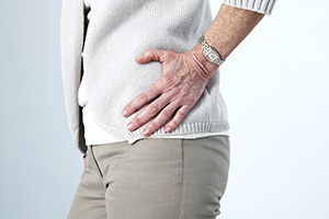 Woman holding hip in pain