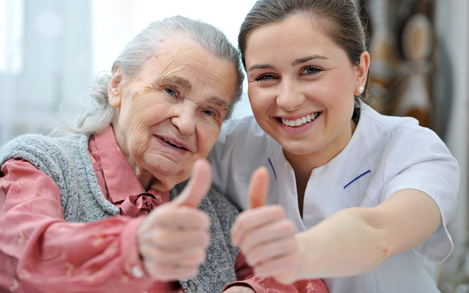 Worker and patient giving a thumbs up