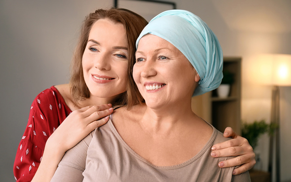 Young woman visiting her mother with cancer indoors