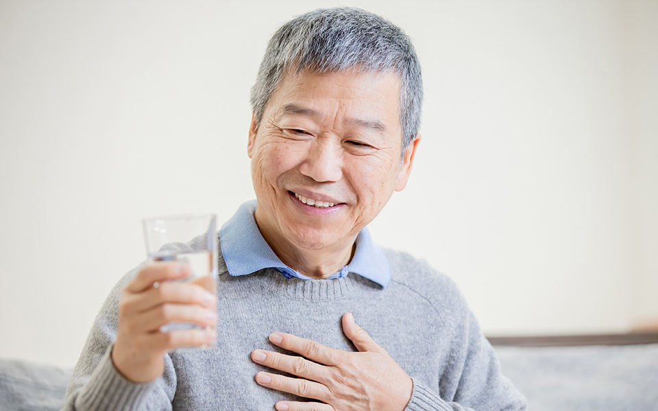 Older man drinking water