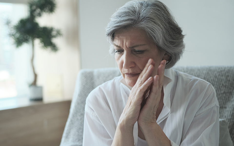 Older lady feeling scared, anxious, and thinking of long COVID Syndrome. Click to learn more.