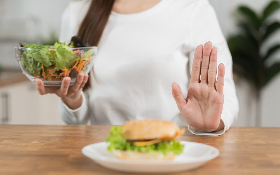 A woman avoiding unhealthy food